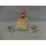 A Royal Doulton figurine and two Doulton posies