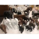A collection of seventeen elephant ornaments