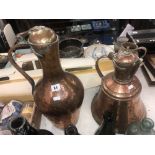 A pair of brass and copper jugs