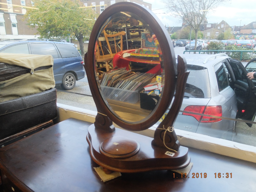 A mahogany swing toilet mirror