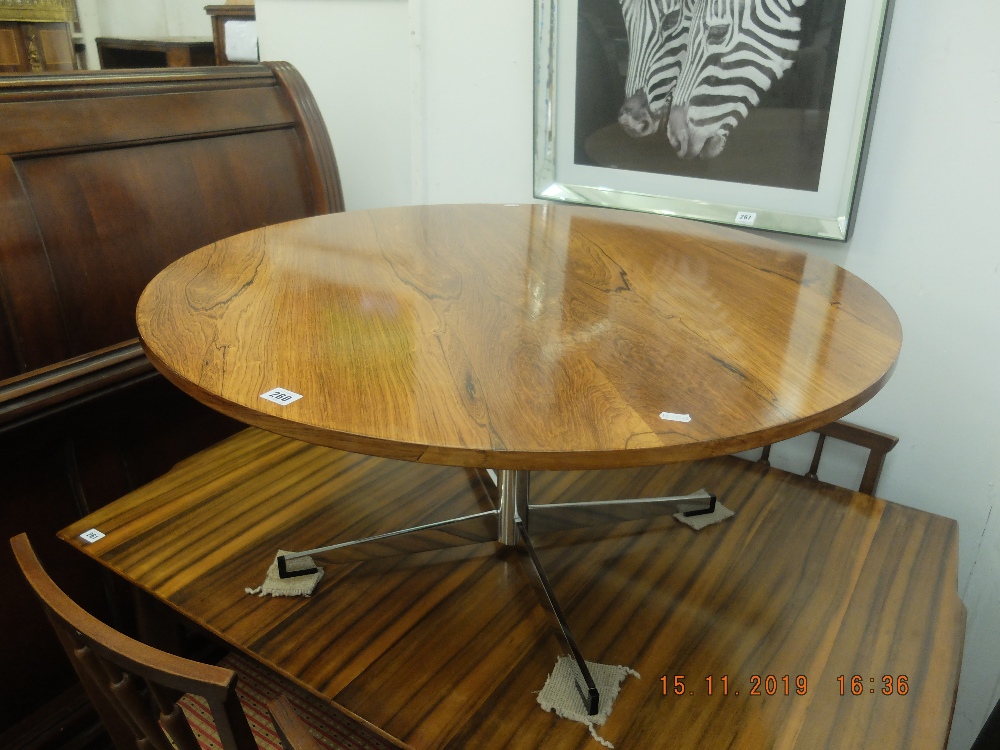 A mid century Heals rosewood coffee table on four star aluminum base possibly by Fitz Hansen