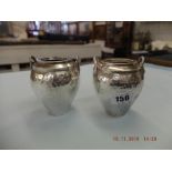 A pair of hammered Sterling silver vases