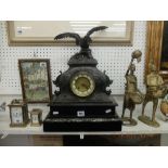 A French spelter clock on marble and black onyx base surmounted with eagle