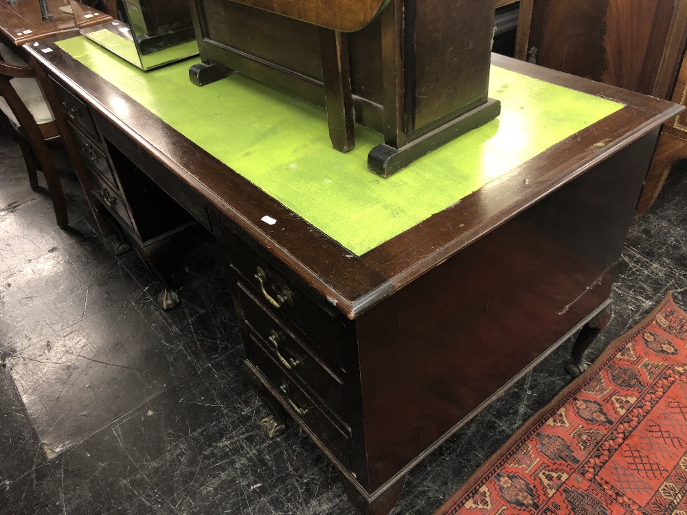 A mahogany pedestal desk with leather insert