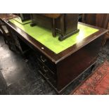 A mahogany pedestal desk with leather insert