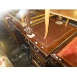 A large mahogany leather top pedestal desk