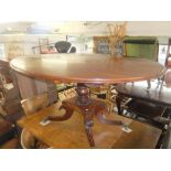 A Regency mahogany oval tilt top table on splayed base