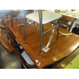 A contemporary extending dining table with two leaves,