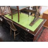 A large mahogany leather top desk