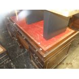 A pedestal desk red leather top