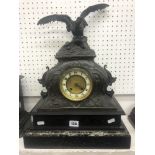 A French spelter clock on marble and black onyx base surmounted with eagle