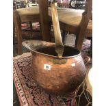 A copper coal scuttle