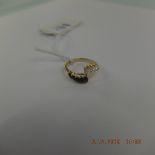 An 18ct yellow gold diamond and sapphire crossover ring size N