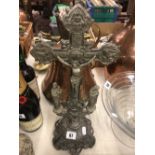 A metal cross on stand