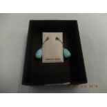 A pair of turquoise and silver drop earrings