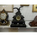 A French spelter clock on marble and black onyx base surmounted with eagle