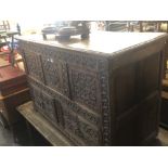 A 19th century carved oak mule chest.