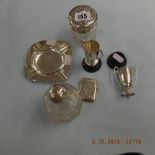 A hallmarked silver vesta case, two silver miniature trophies, silver ashtray,