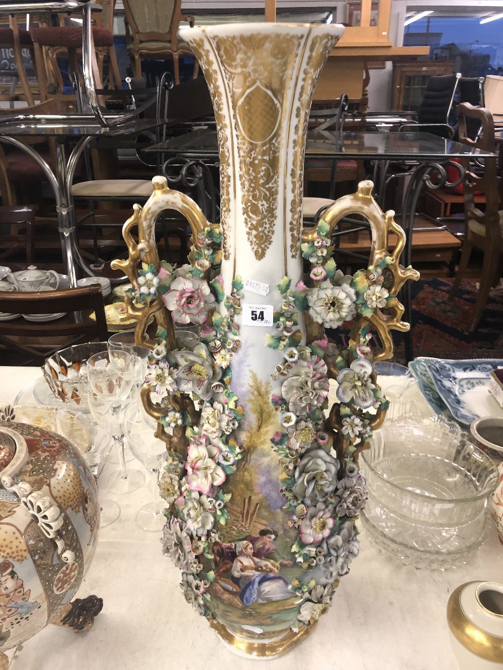 A fine quality twin handle continental porcelain in style of Meissen with applied flowers,