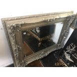 A large silver gilt framed mirror