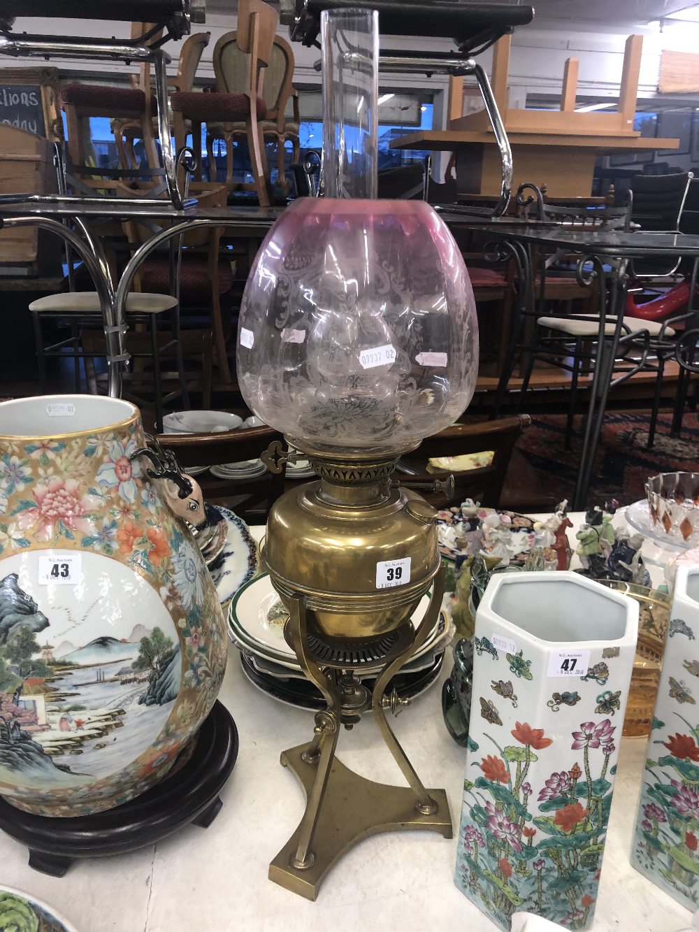 A Victorian brass oil lamp Cranberry shade