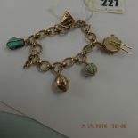 A 9ct gold charm bracelet with assorted yellow metal charms,