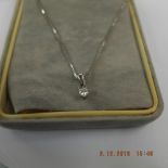 An 18k white gold diamond solitaire pendant on chain weight 2 grams