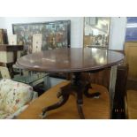 A Regency mahogany oval tilt top table on splayed base