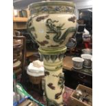 A fine quality Majolica ware jardiniere on stand with applied dragon decoration. Dimensions.
