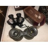 A cased set of binoculars and one other