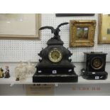 A French spelter clock on marble and black onyx base surmounted with eagle