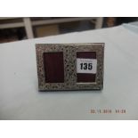 A hallmarked silver miniature double photo frame