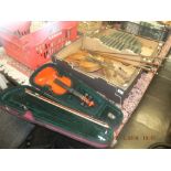 A cased child's violin and two others