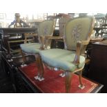 A pair of tapestry upholstered walnut framed armchairs