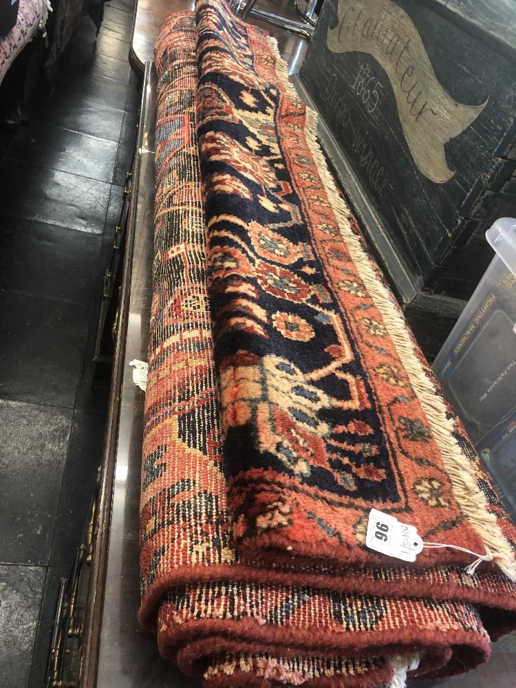 A red ground Persian rug, good condition,