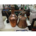 A pair of brass and copper jugs