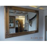 A gilt framed mirror