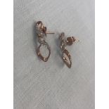 A pair of 9ct gold diamond set earrings