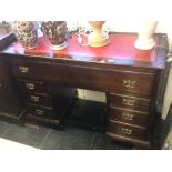 A mahogany pedestal desk with leather insert
