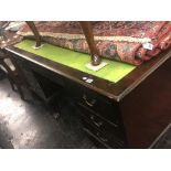 A large mahogany leather top desk