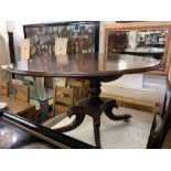 A Regency mahogany oval tilt top table on splayed base