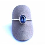 Bague or blanc centrée en clos d'un saphir ovale probablement Ceylan d'un bleu [...]