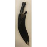 GURKHA KUKRI KNIFE. A Kukri knife with scabbard and miniature blade in scabbard.