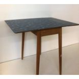 1960S FOLDABLE TABLE. A stylish foldable table with laminate top, removable legs. Circa 1960s.