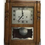 VEDETTE. A French Art-deco style Vedette pendulum clock with carved wooden casing.