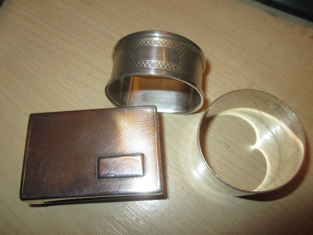 2 x silver serviette rings and silver matchbox holder with engine turned decoration 65 g