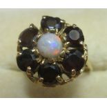 9 ct gold ring set with a cluster of garnets surrounding a single opal 53, 4.