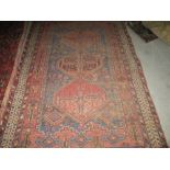 Semi antique wool rug with three central lozenges 190 cms x 128 cms