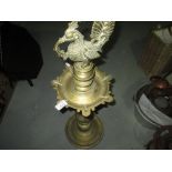 Early 20th century Indian brass rush candle stand modelled with bird finial