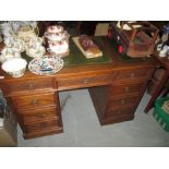 Oak veneered carved twin pedestal writing desk with leather skiver